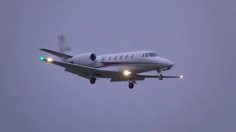 Business jet (private jet) landing at dusk Stock Footage 126254701