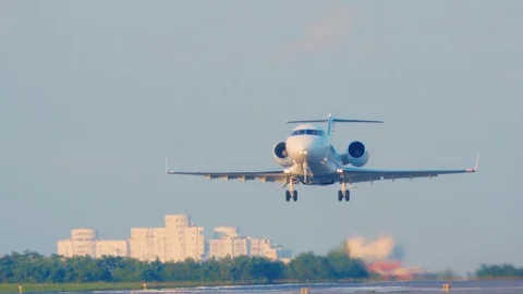 Business jet is taking off at sunset. Private jet, or bizjet takes off at dawn Stock Footage