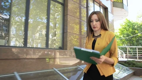 Business lady is angry and throws financial documents out of green folder Stock Footage 83787366