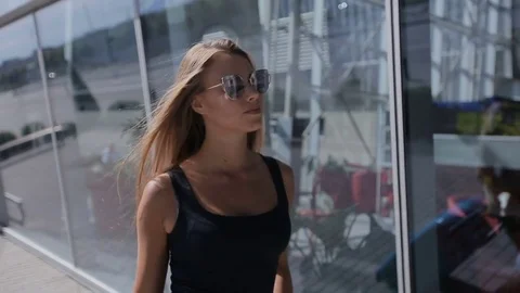 Business lady going to the airport with her luggage. Business trip concept Stock Footage