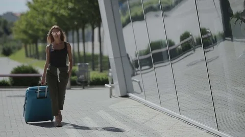 Business lady going to the airport with her luggage. Business trip concept Stock Footage