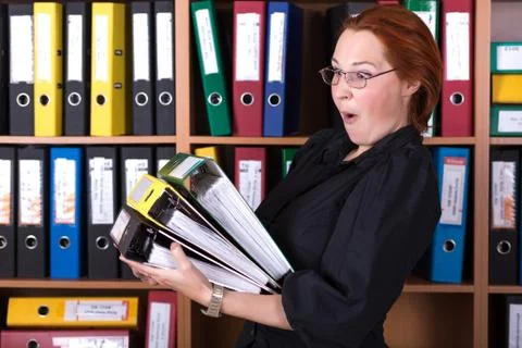 Business Lady holding large Stack of Office Folders Stock Photos