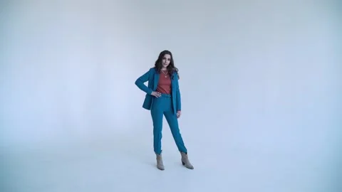 A business lady poses in a blue jacket and trousers on a white background. The Видео 137084508