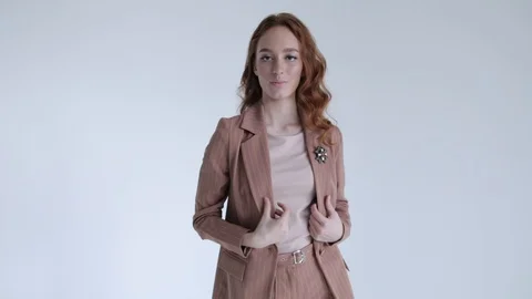 Business lady posing in a brown jacket and trousers on a white background. Sexy Stock Footage 106282434