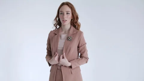 Business lady posing in a brown jacket and trousers on a white background. Sexy Stock Footage 106282710