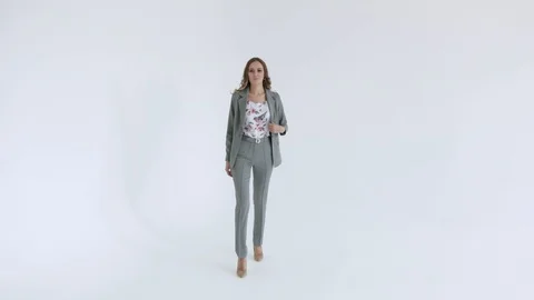 Business lady posing in a gray jacket and trousers on a white background. Sexy Stock Footage 106282167