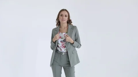 Business lady posing in a gray jacket and trousers on a white background. Sexy Stock Footage 106282217