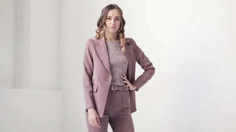 Business lady posing in a jacket and trousers on a white background. Stock Footage 105008271