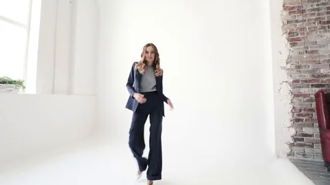 Business lady posing in a jacket and trousers on a white background.  Video stock 105008375