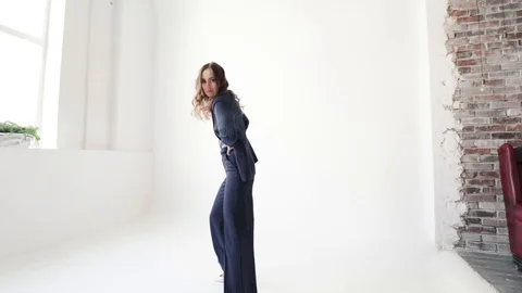 Business lady posing in a jacket and trousers on a white background.  Stock Footage 105008382