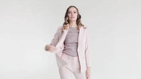 Business lady posing in a white jacket and trousers on a white background.  Stock Footage 105007864