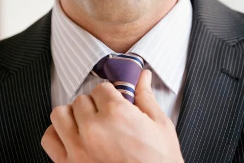 Business man adjusting tie, close up Stock Photos