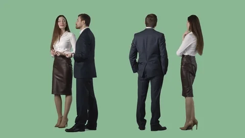 Business man and elegant female are standing, looking at something, discussing Stock Footage