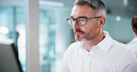 Business, man and reading on computer in office for insurance auditing, finance Stock Photos