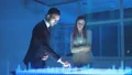 The business man and a woman discussing near the virtual screen 4k or 4k+ Resolution