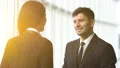 The business man and a woman talking in the office on a sunny background 4k or 4k+ Resolution