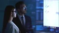 The business man and a woman talking near the display 4k or 4k+ Resolution