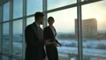 The business man and a woman walking near windows. slow motion HD Footage