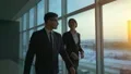 The business man and a woman walking along the window. slow motion HD Footage