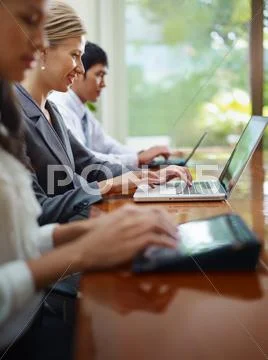 Business man and women typing on pc during meeting Stock Photos