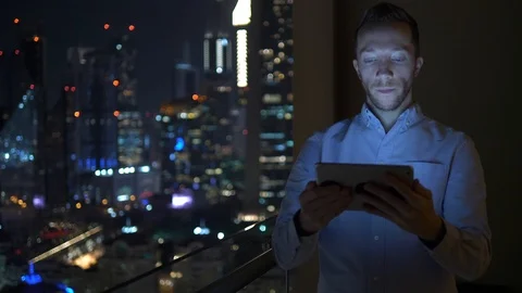 Business Man Browsing Web Online Using Mobile Device in City Office at Night  Stock Footage 103599896