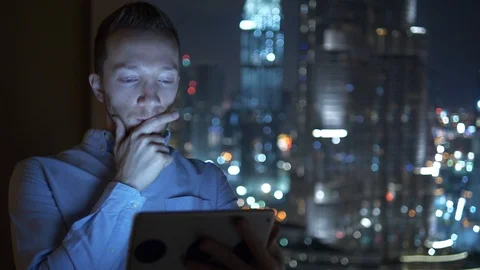 Business Man Browsing Web Online Using Mobile Device in City Office at Night  Stock Footage 103599992