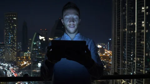 Business Man Browsing Web Online Using Mobile Device in City Office at Night  Stock Footage 103600146