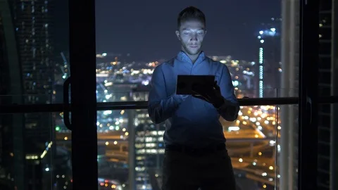Business Man Browsing Web Online Using Mobile Device in City Office at Night  Stock Footage 103600700