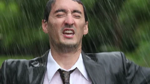 Business man celebrating in rain Stock Footage