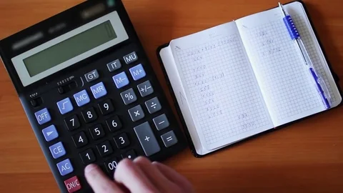 Business man checking numbers on calculator Stock Footage 75964358