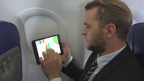Business Man Checking Pie Chart on Digital Tablet Airplane Interior Travel Male Video stock 73578453