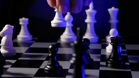 Business man chess at table. Player makes a move, developing chess strategy. Stock Footage 145273299