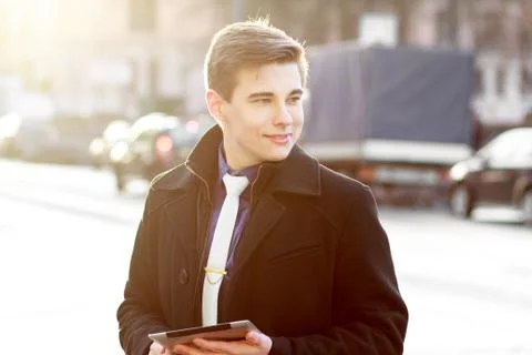 Business man in coat using tablet Stock Photos