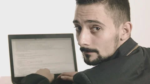 Business man computer programmer typing at his desk and looking at camera Stock Footage 45885479