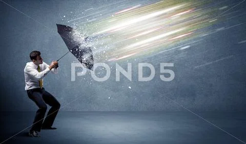 Business man defending light beams with umbrella concept Stock Photos