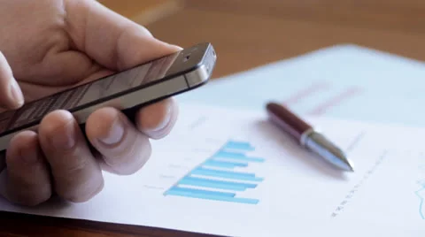 Business man at desk using smartphone, tracking Stock Footage 25850169