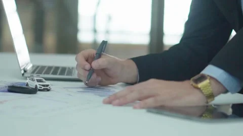 A business man documents on office table with laptop and graph business. Video stock 242096594