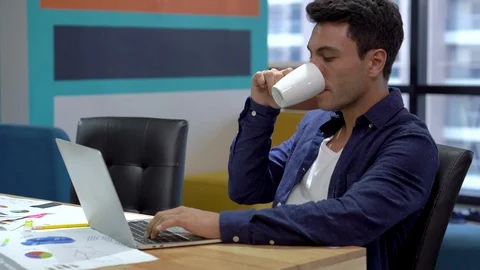 Business man drinking coffee and  typing on laptop keyboard working in the  m Stock Footage 112729924