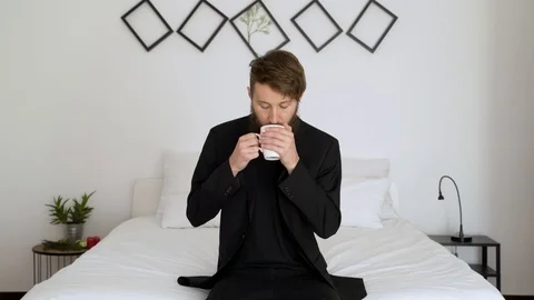 Business man drinking coffee in an authentic room cheers to camera. Video stock 102655454