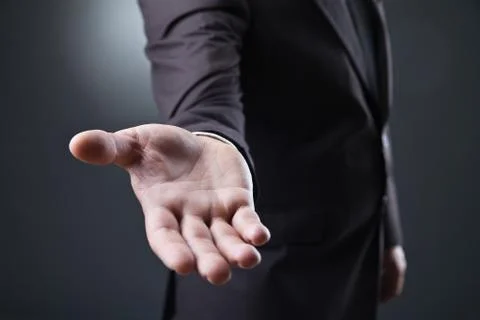 Business man with empty hand on dark background Stock Photos