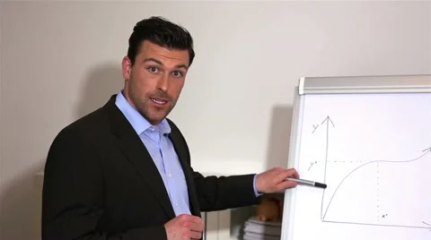 Business man explaining graph on flipchart Stock Footage 11019548