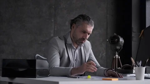 Business man is focused on documents. Portrait of middle aged man in office. Stock Footage 108615324