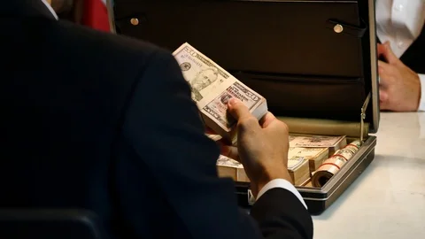 Business man giving bribe money in a briefcase Stock Footage