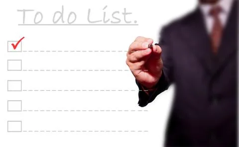 Business man hand checking the to do list. Stock Photos