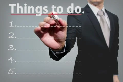 Business man hand checking the things to do. Stock Photos