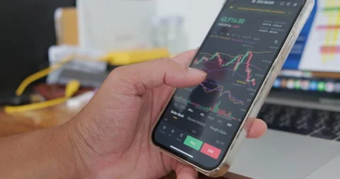 Business man hand trader use mobile phone analyst graph of Bitcoin Stock Footage 170169074
