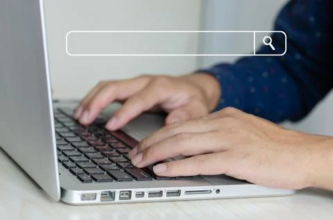 Business man hand using a laptop keyboard is searching for information on t.. Stock Photos