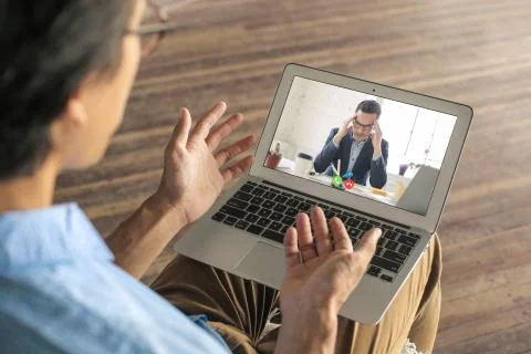 Business man having a difficult video call, talking about some work problems Stock Photos