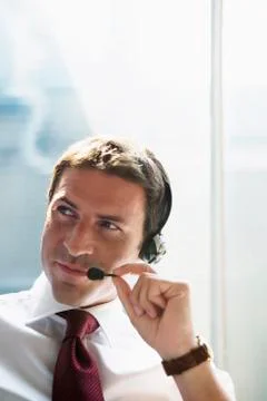 Business man with head set, skyping Stock Photos