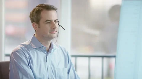 Business man with headset looking at screen Video stock 61359373